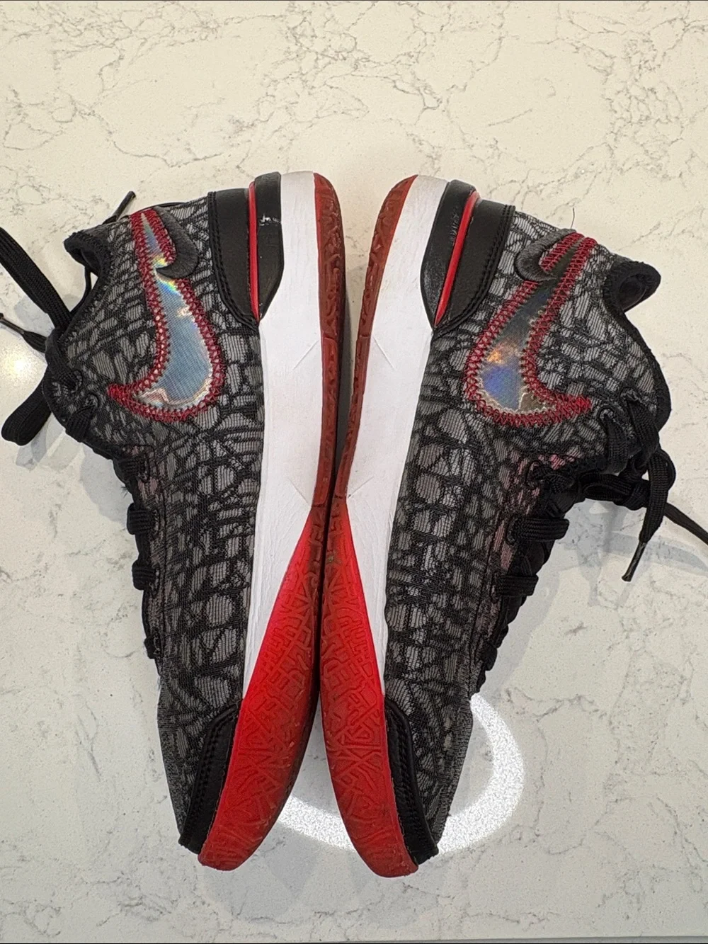 Nike Kids Black and Red Sneakers with Iridescent Swoosh
